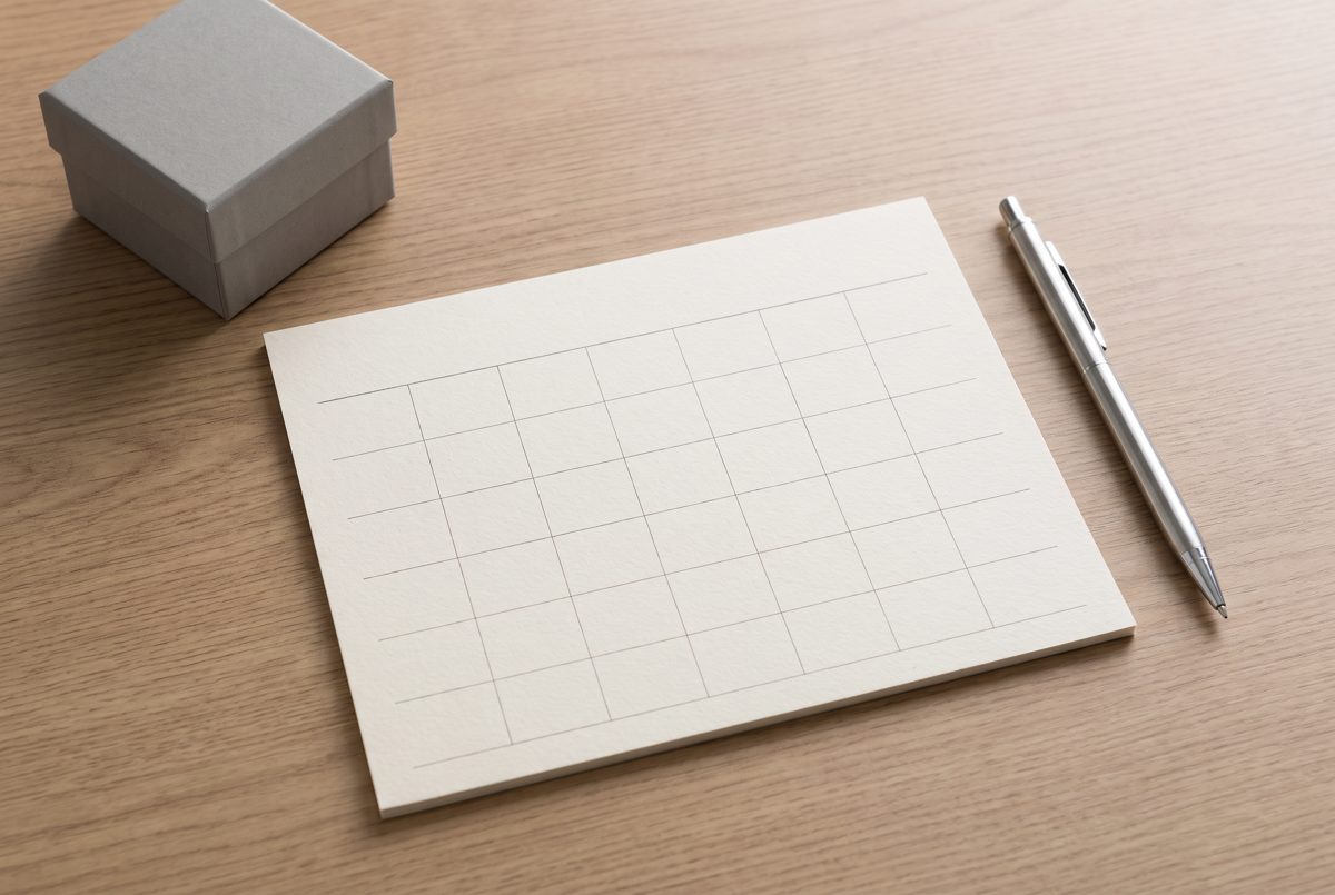 Planning a corporate gift order timeline on a calendar with a grey gift box